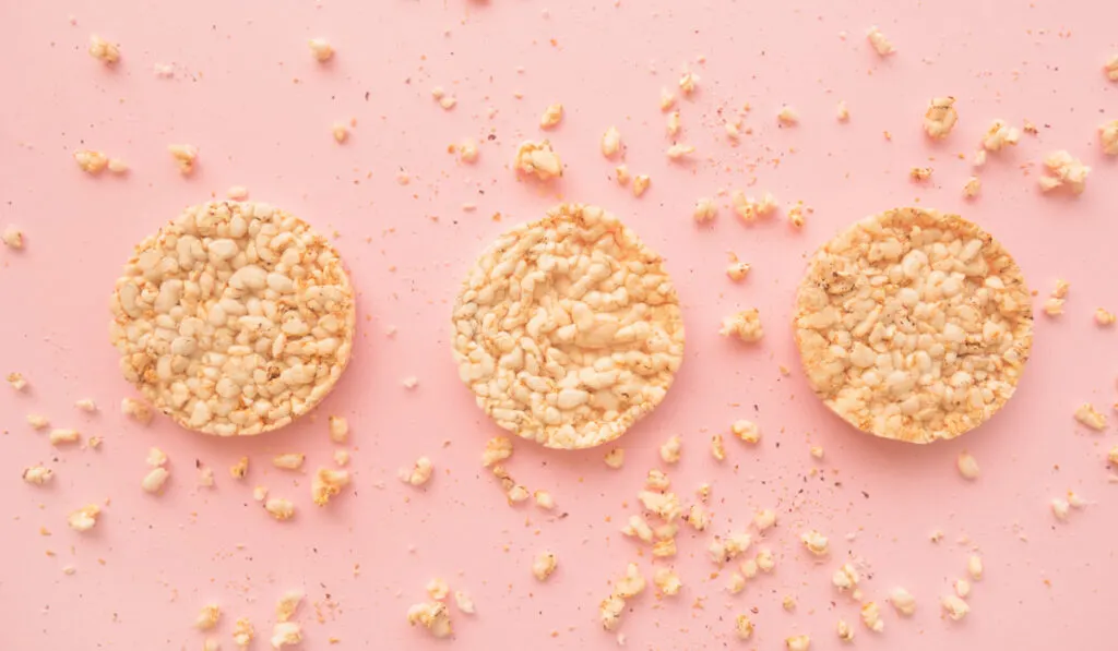 Flat lay crunchy rice cakes on pink background